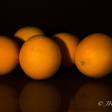Oranges waiting in the shadows